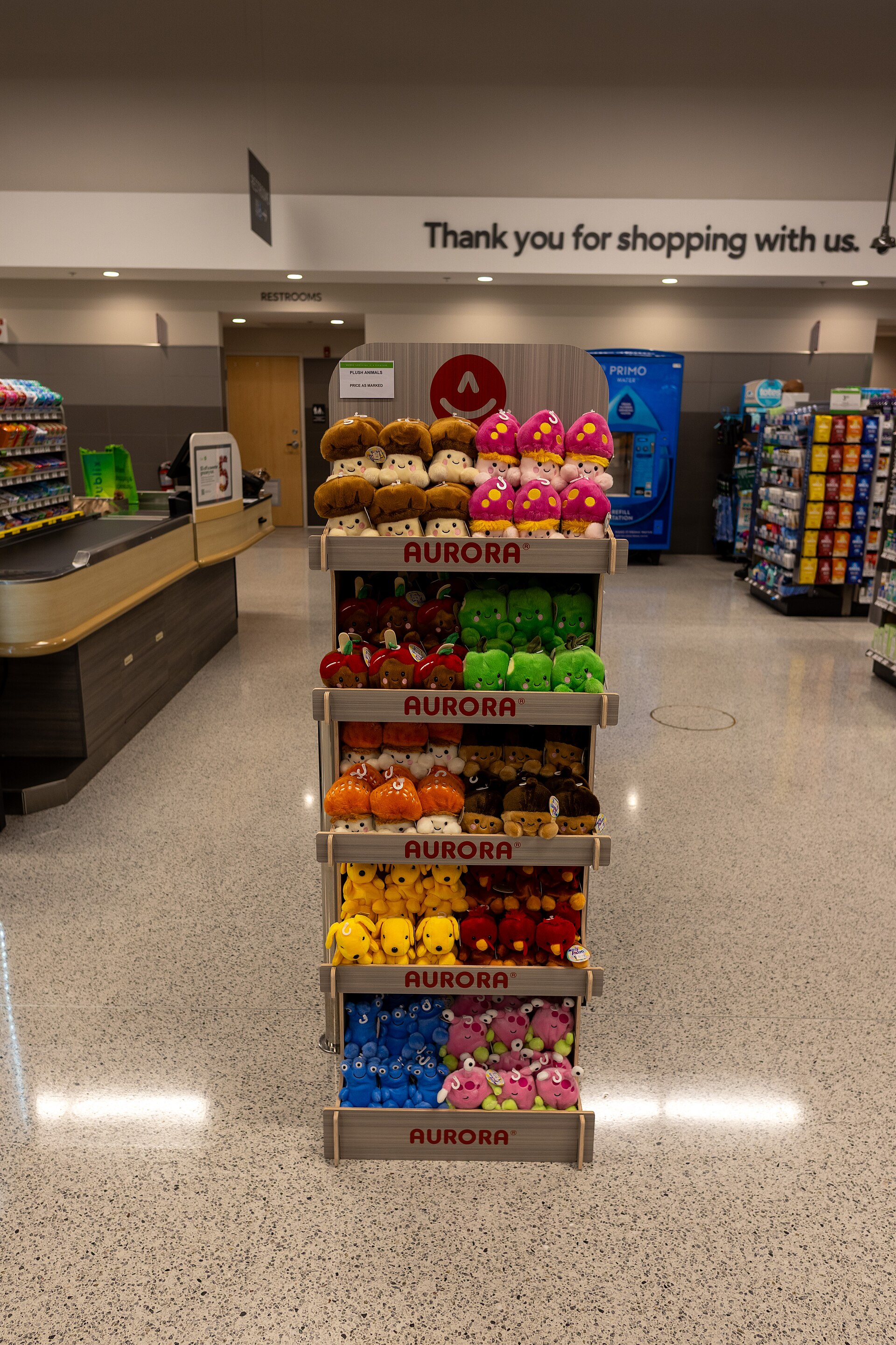 Colorful readymade plush toys displayed together on retail shelves